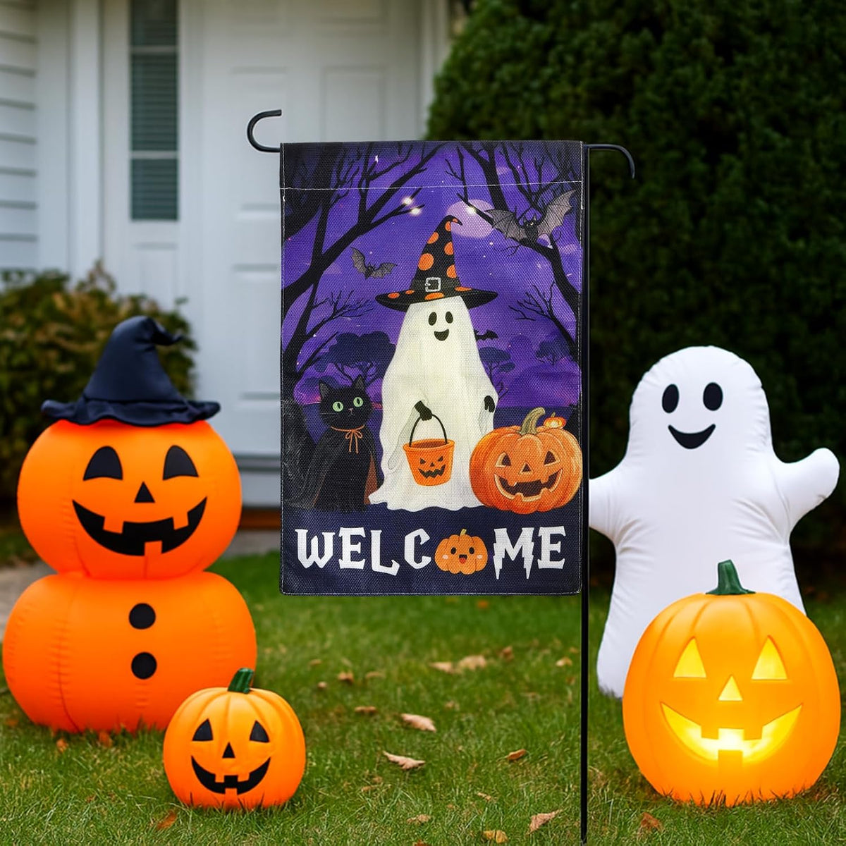 Halloween welcome flag with pumpkins and inflatable ghost on lawn