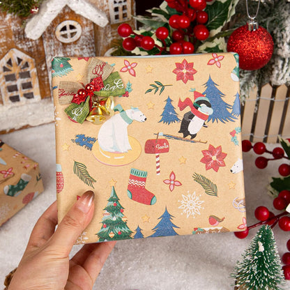 Hand holding gift in kraft paper with polar bear, penguin