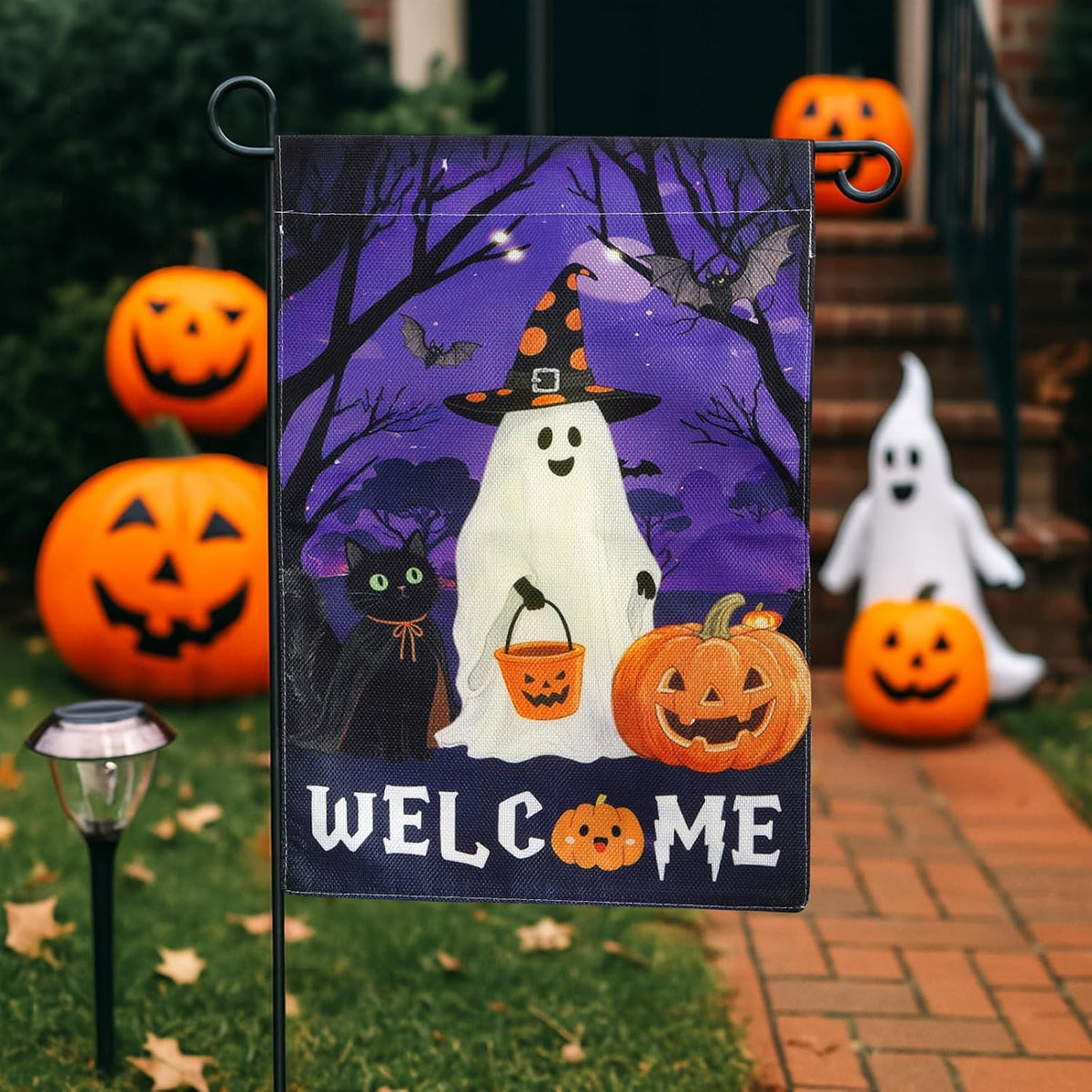 Ghost Halloween welcome flag on stand by pumpkins